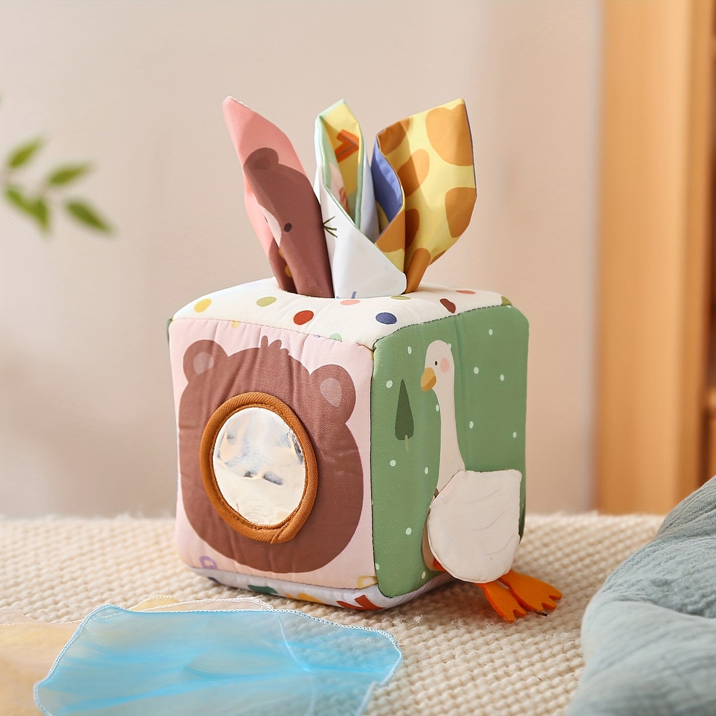 Colorful sensory tissue play box toy designed to encourage fine motor skill building and tactile play in young children.