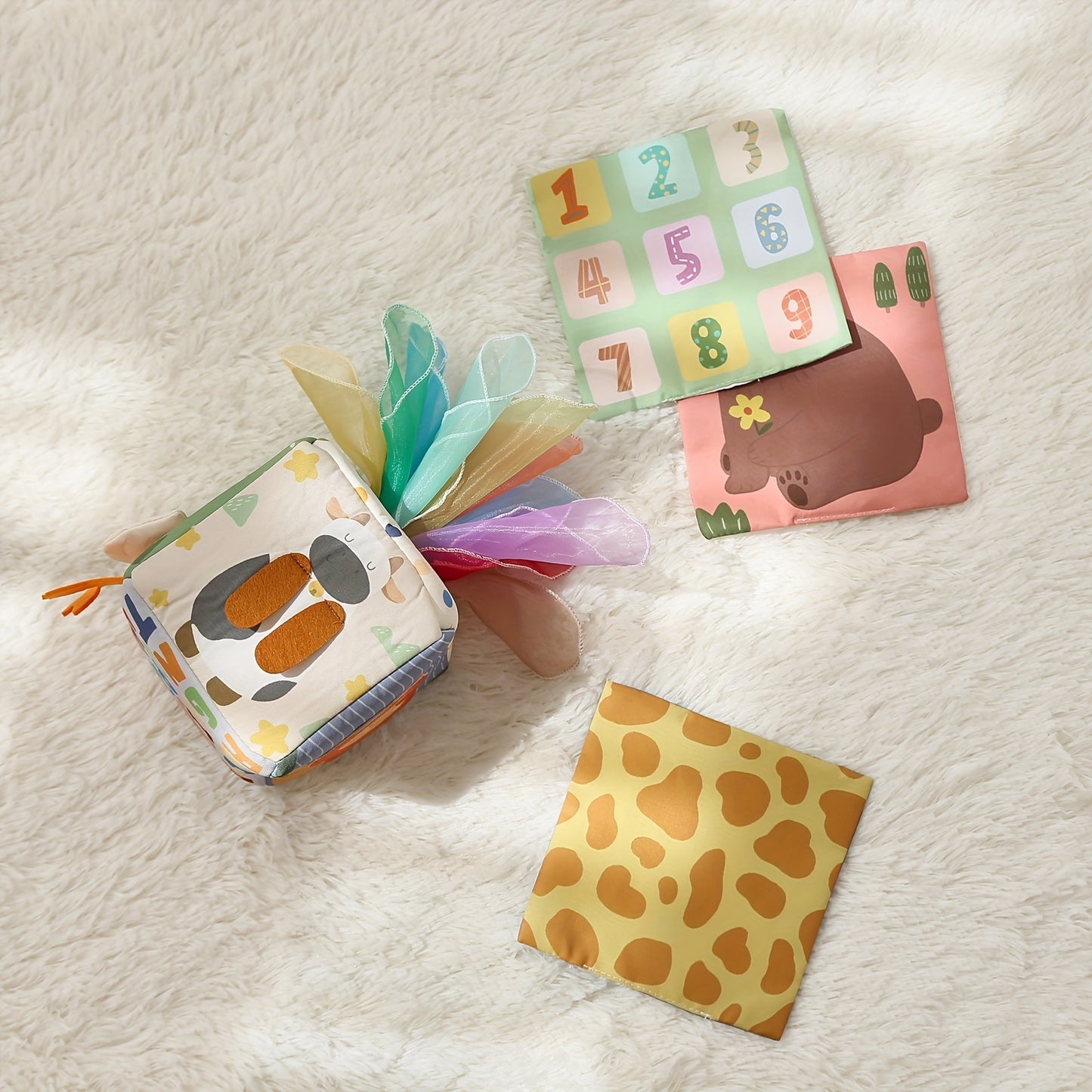 Bright tissue play box toy with soft tissues to support sensory development and hand coordination in babies.