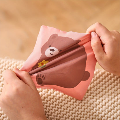 Early learning tissue play box toy featuring colorful tissues for stimulating babies’ sense of touch and motor skills.