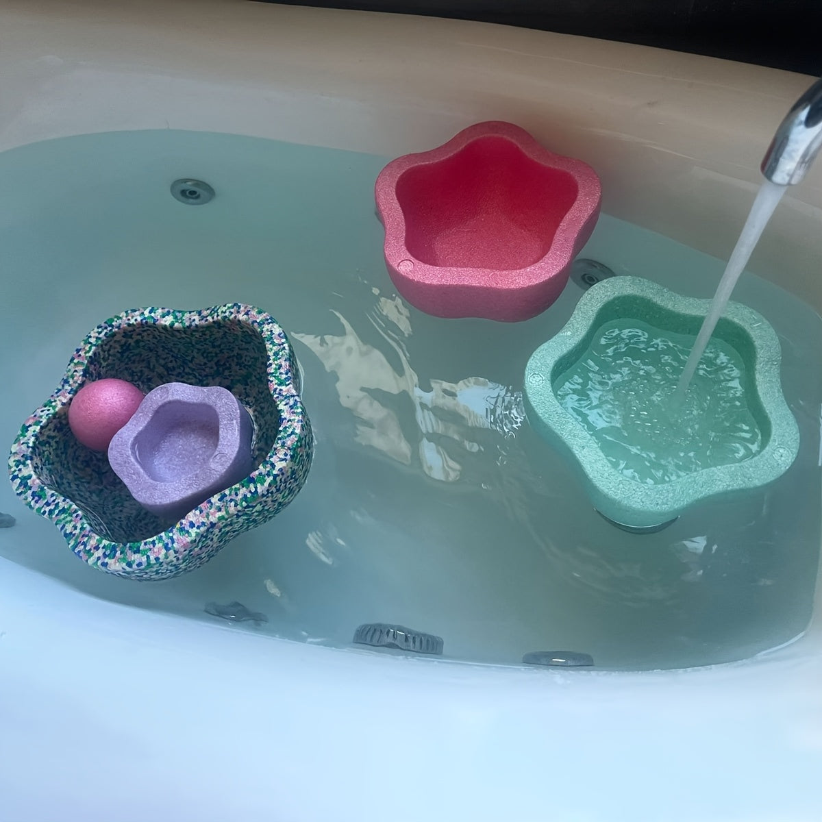 Blue and pink stone set shown in bath tub for versatile and multi-purpose play.