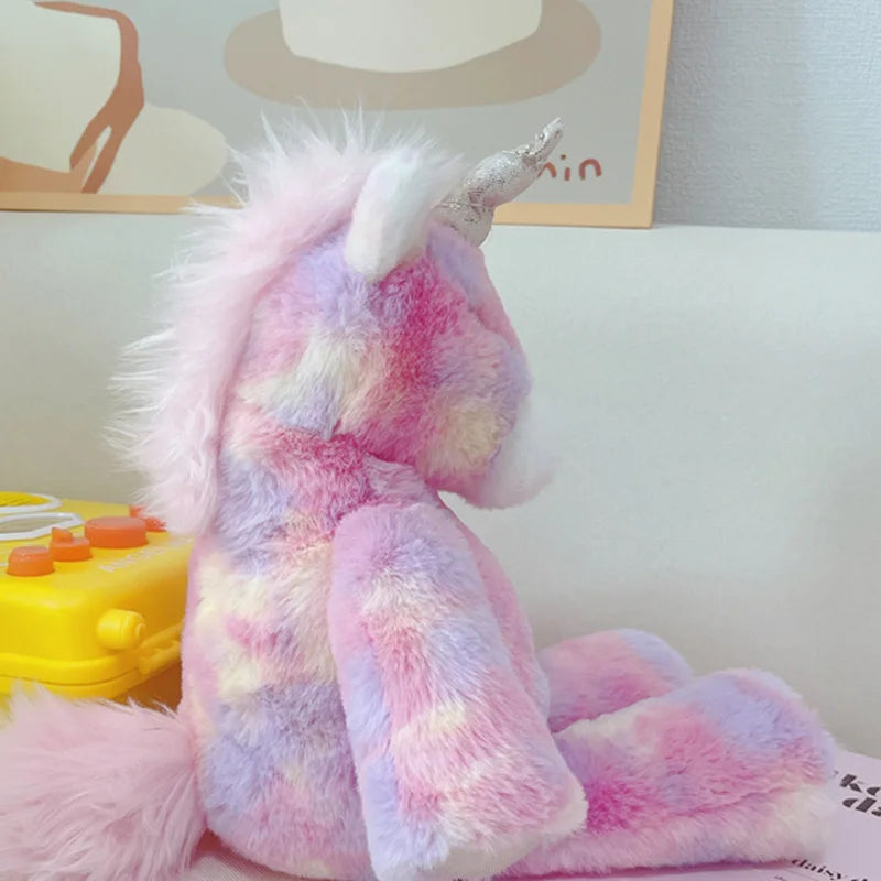 Pastel-colored plush unicorn toy on a light surface with a blurred background