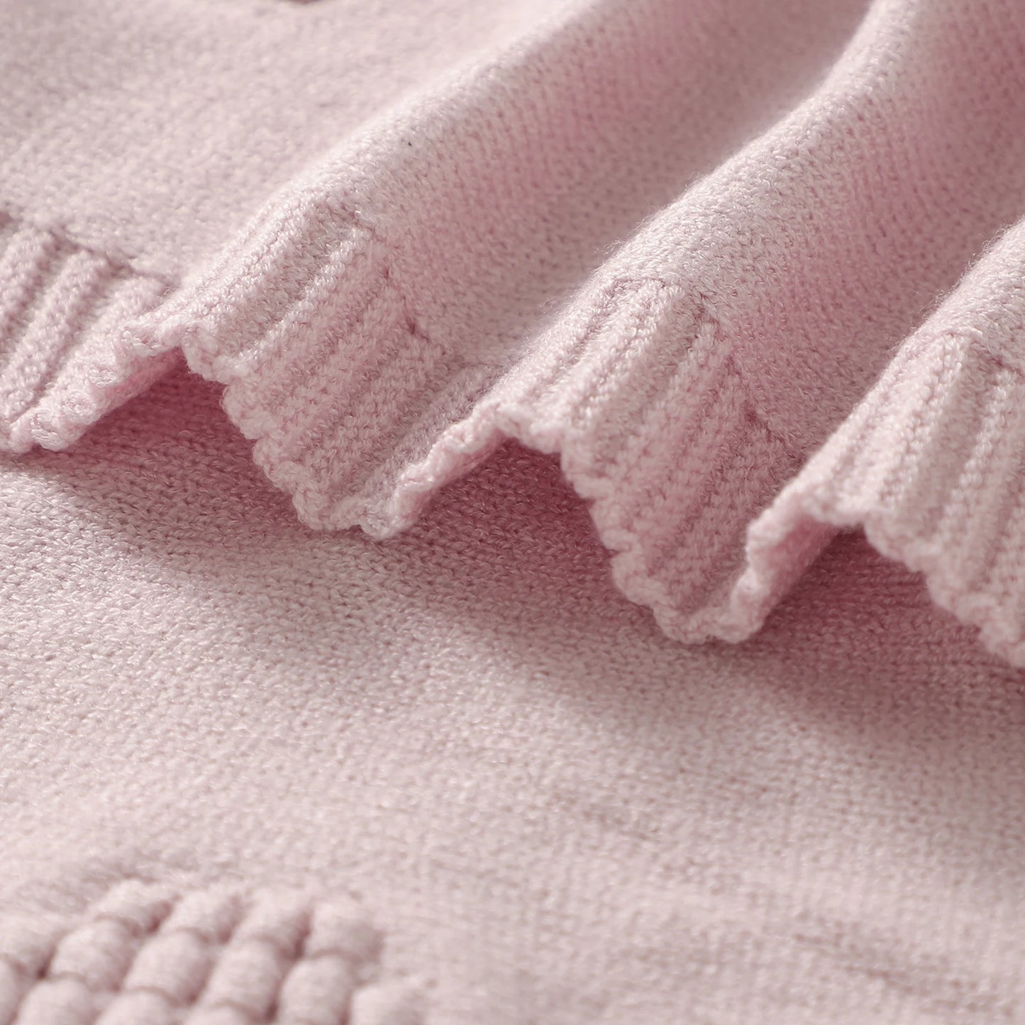 Close-up of a pink textured fabric with ruffled edge