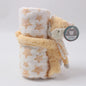 Plush toy fox with star pattern wrapped in a blanket on a white background