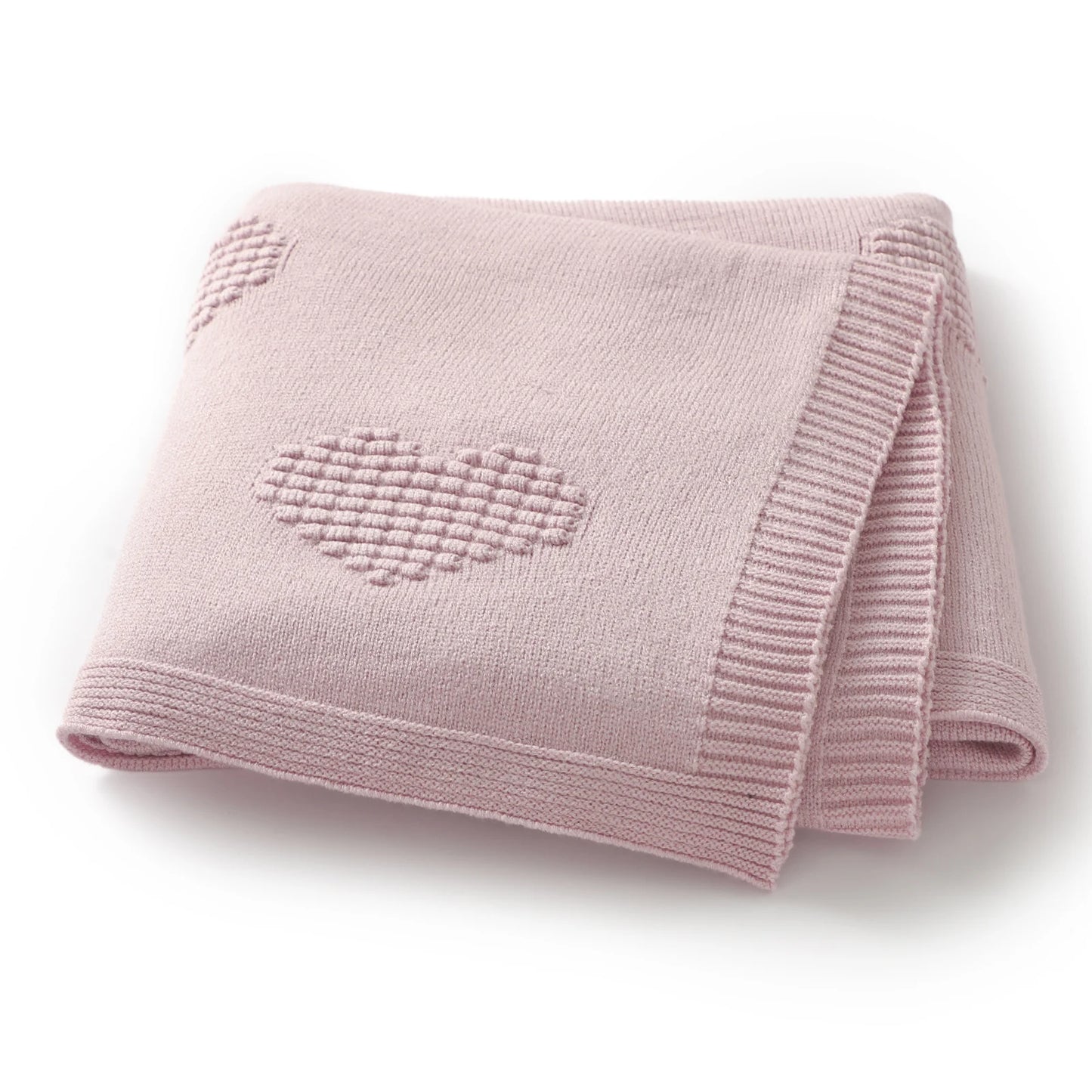 Pink knitted blanket with a heart design on a white background