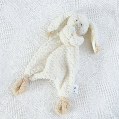 White plush bunny toy on a textured white surface