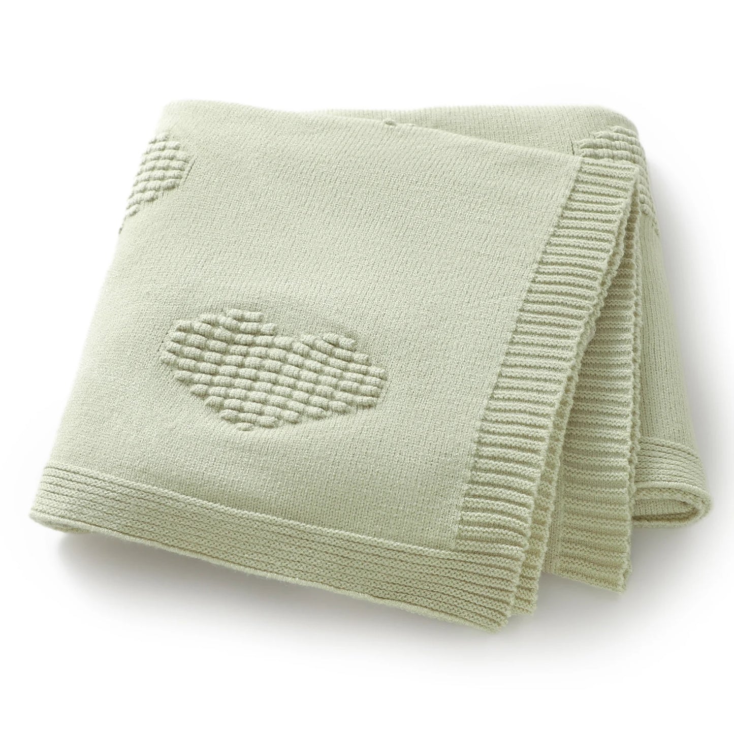 Light green knitted blanket with a heart design on a white background