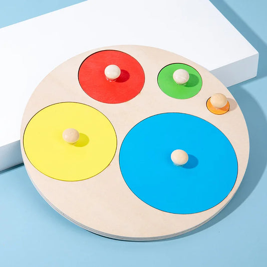 Five circular wooden pegs placed in size order on Montessori puzzle.