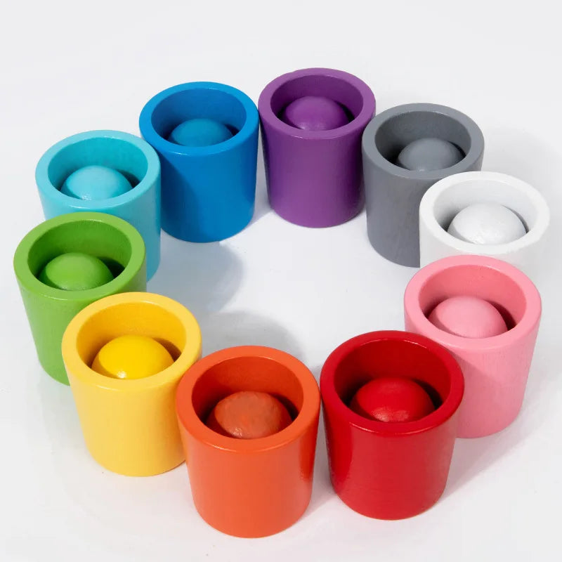 Montessori balls in cups set with colorful wooden balls and matching cups designed for sorting and fine motor skills.