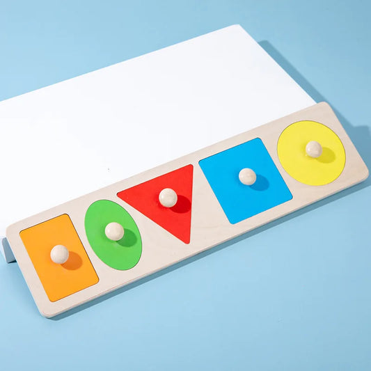 Set of geometric shape puzzles laid out on wooden Montessori board.
