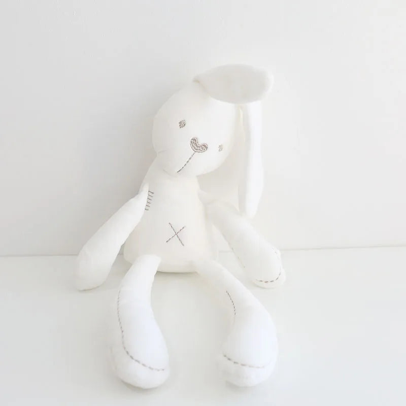 White plush toy with a heart design on a light gray background