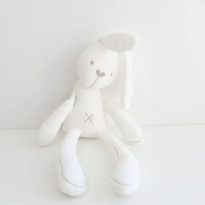 White plush toy with a heart design on a light gray background