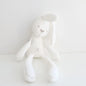 White plush toy with a heart design on a light gray background