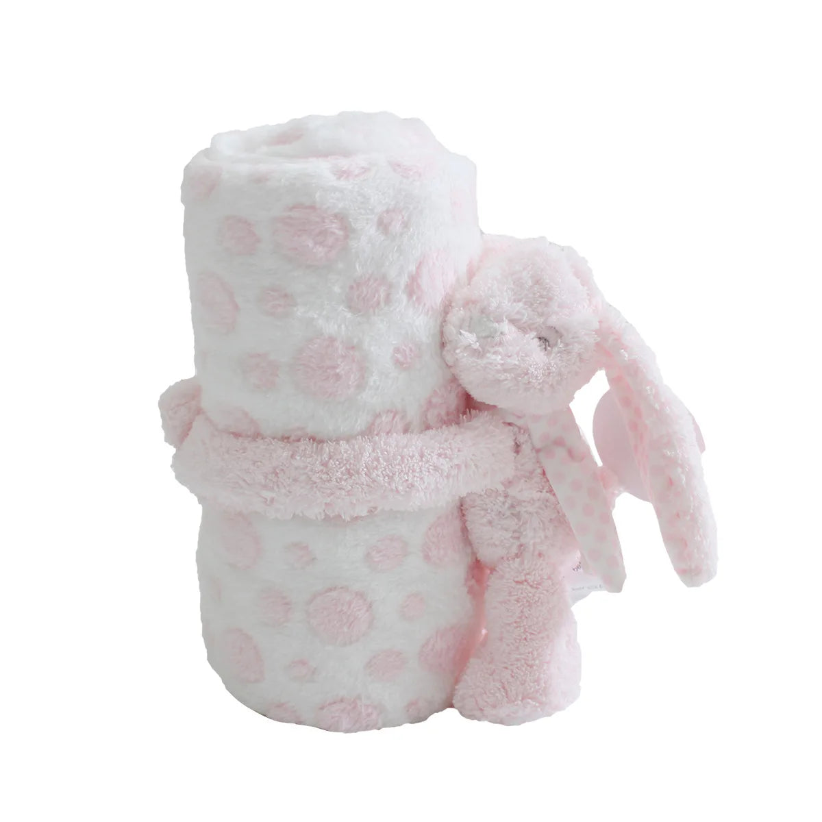 Fluffy pink and white polka dot blanket with a bunny toy on a white background