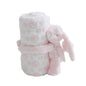 Fluffy pink and white polka dot blanket with a bunny toy on a white background