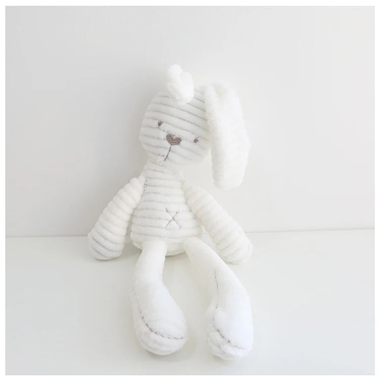 White plush toy with a subtle pattern on a light gray background