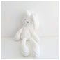 White plush toy with a subtle pattern on a light gray background