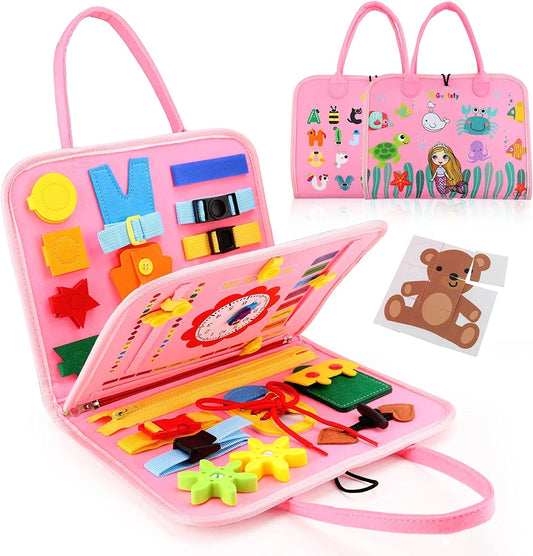 Pink Montessori busy board with buttons, zippers, and buckles for toddlers