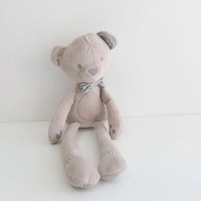Stuffed teddy bear with a bow tie on a white background