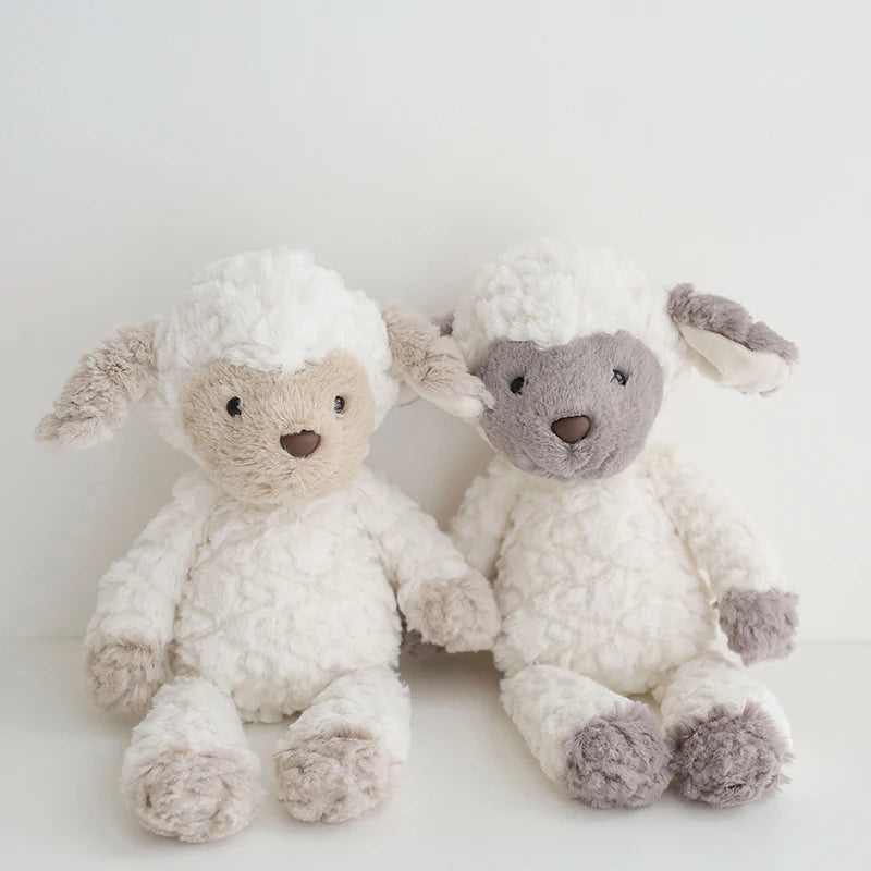 Two fluffy toy sheep on a light background