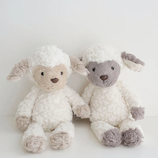 Two fluffy toy sheep on a light background