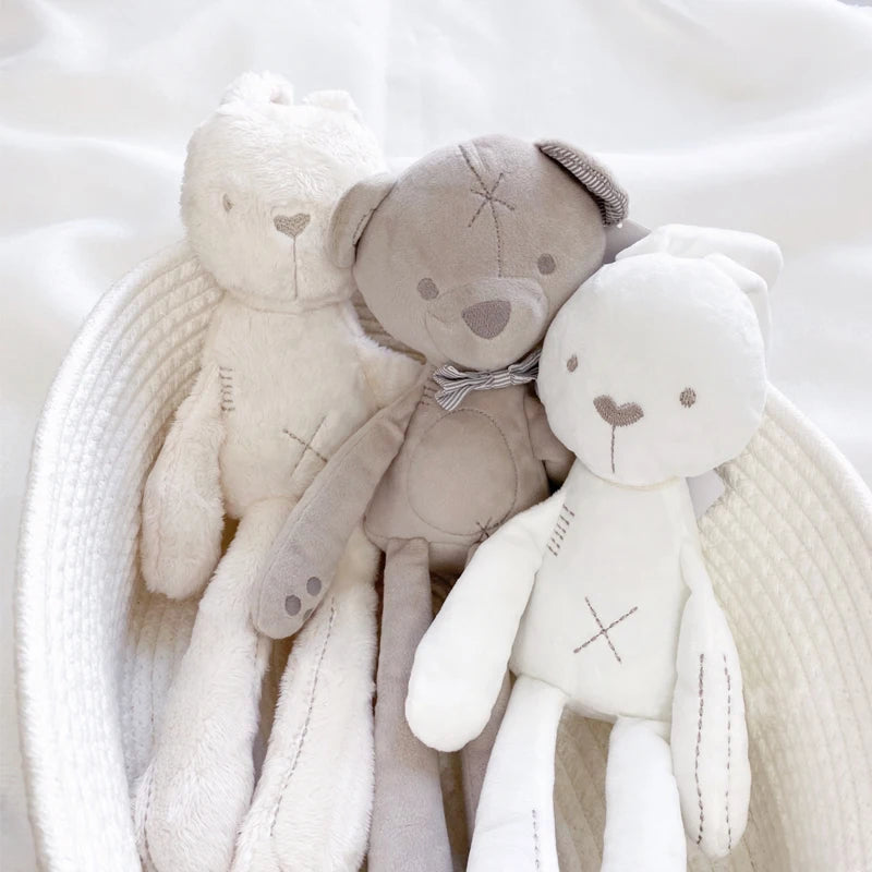 Three soft toys, including a bear and a bunny, on a white background