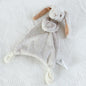Grey plush bunny toy on a textured white surface