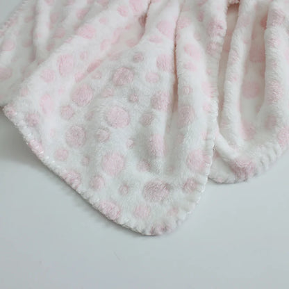 Fluffy pink blanket with a subtle pattern on a light gray background