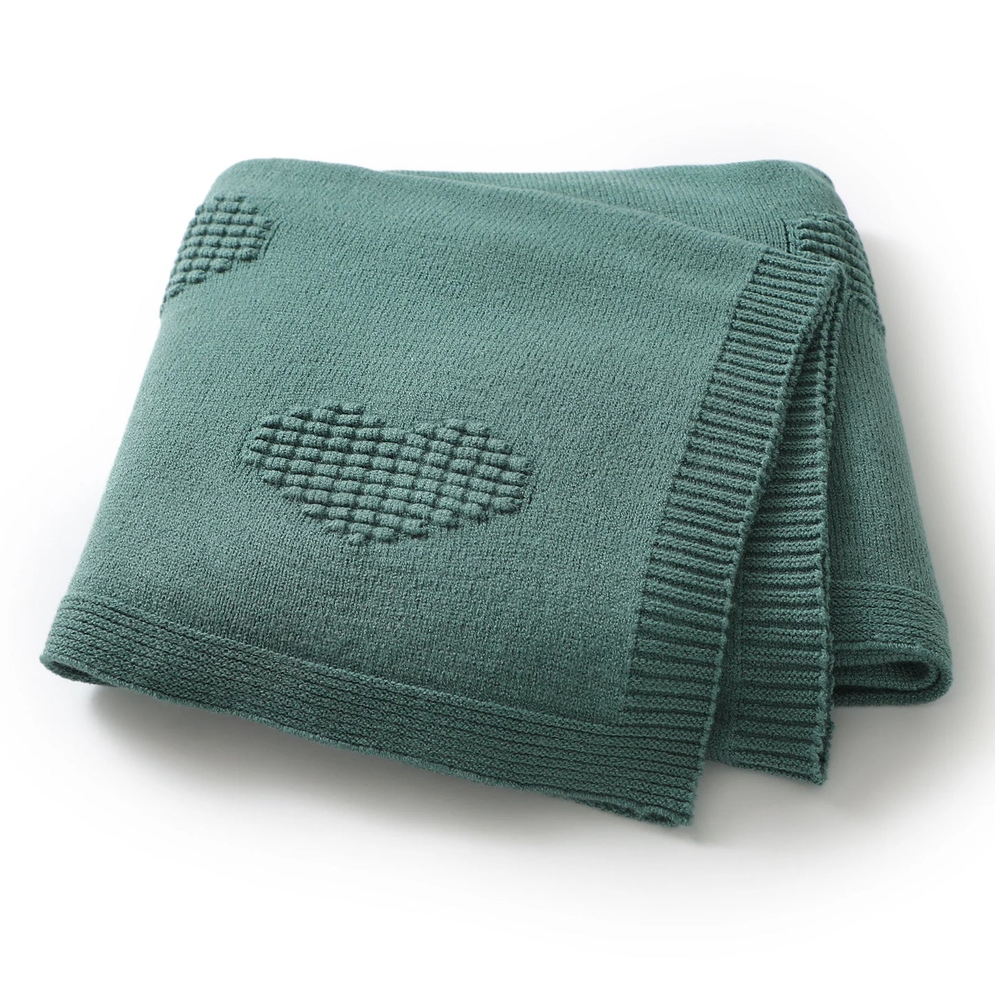 Green knitted blanket with heart patterns on a white background