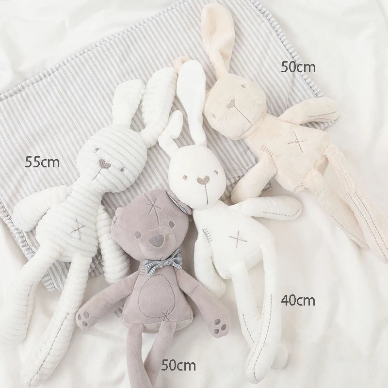 Plush toys with size measurements on a soft fabric background