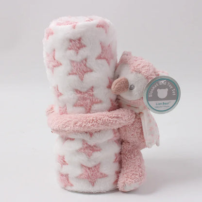 Pink and white star-patterned blanket with a plush owl toy on a light gray background